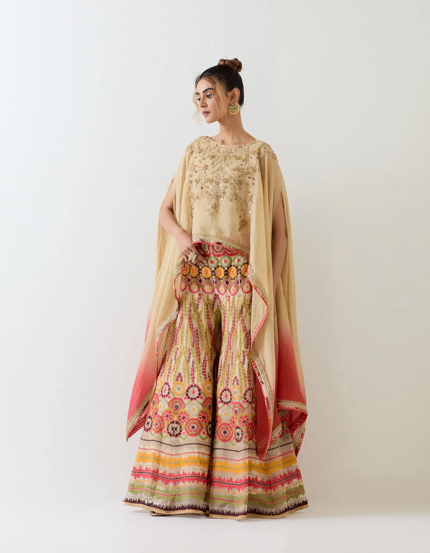 Tissue chanderi dupatta cape embellshed with intricate hand embroidery paired with organza cross stitch embroidered sharara pants