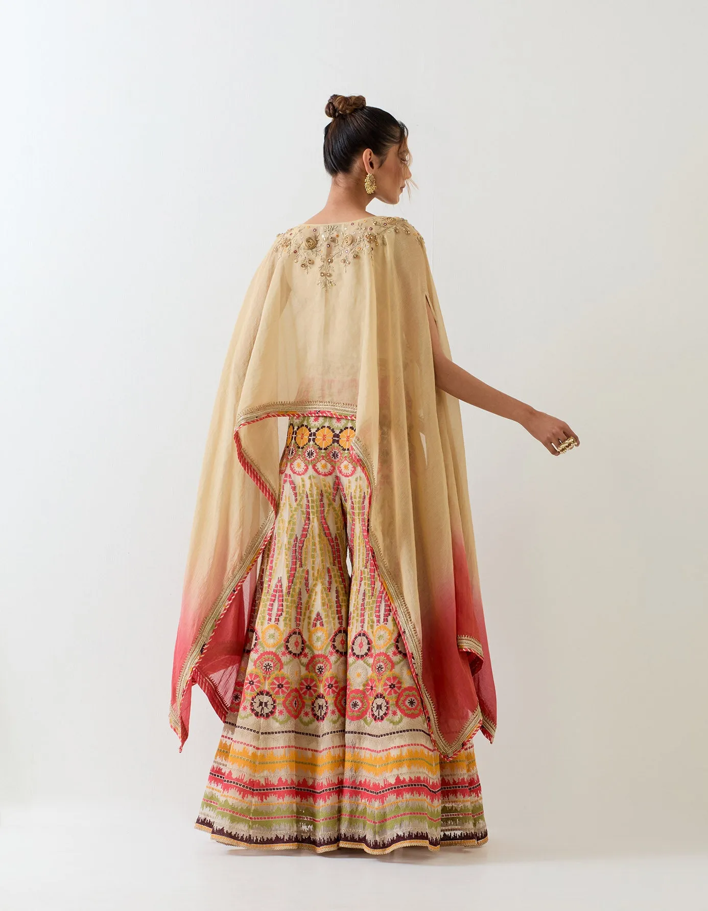 Tissue chanderi dupatta cape embellshed with intricate hand embroidery paired with organza cross stitch embroidered sharara pants